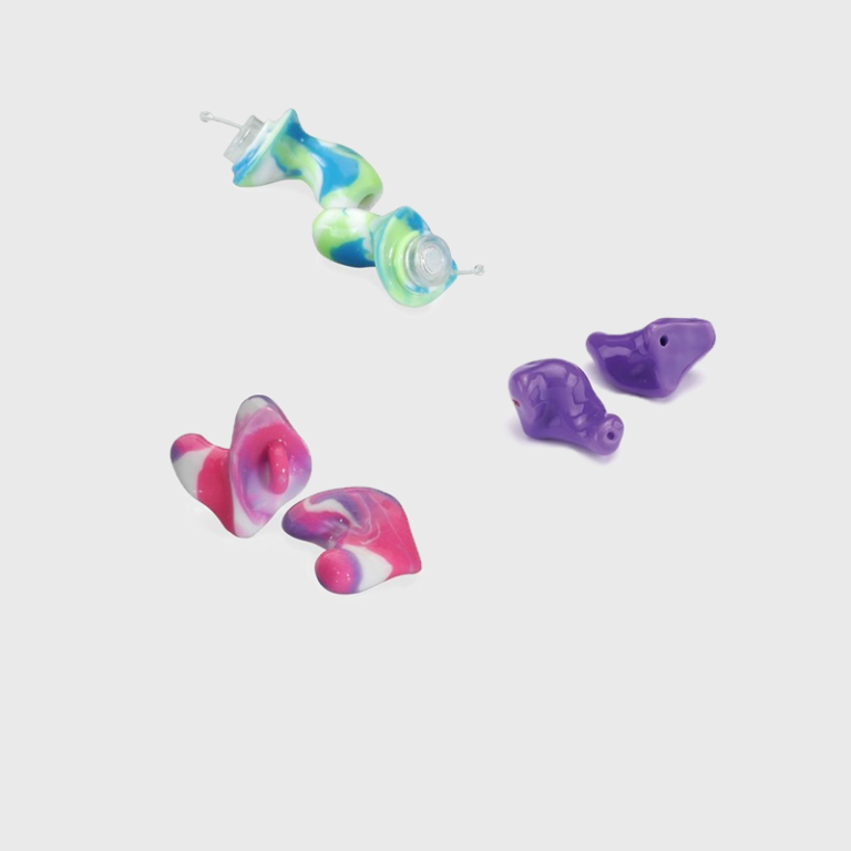 Three sets of custom earplugs of various colors. Colors include solid purple, blue and green swirl, pink and purple swirl